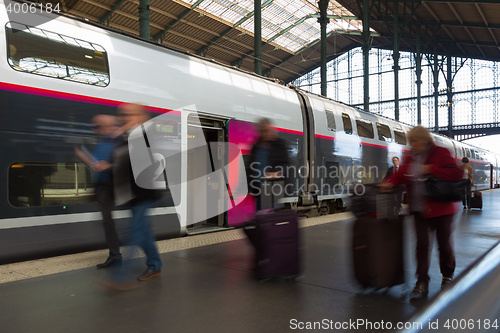 Image of People coming to or leaving train station platform.