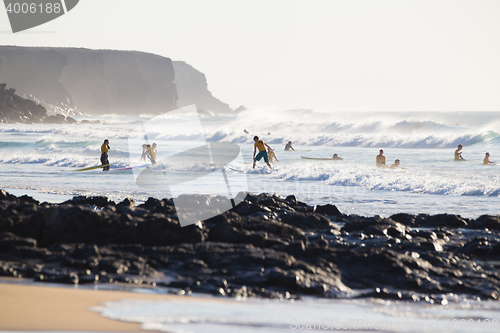 Image of Surfers surfing on El Cotillo beach, Fuerteventura, Canary Islands, Spain.