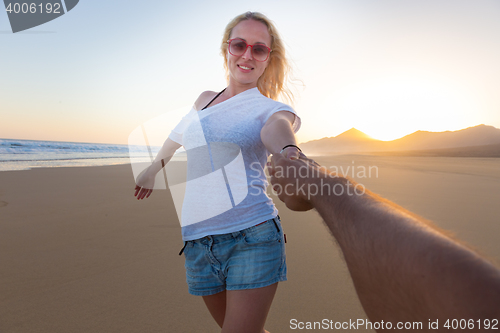 Image of Romantic couple, holding hands,  on beach.