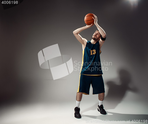 Image of Full length portrait of a basketball player with ball