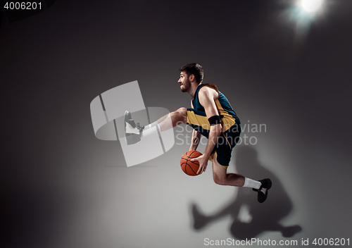 Image of Full length portrait of a basketball player with ball