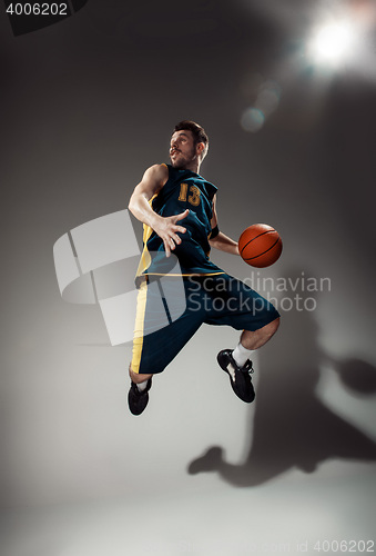 Image of Full length portrait of a basketball player with ball