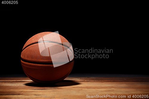 Image of Basketball on a hardwood court floor