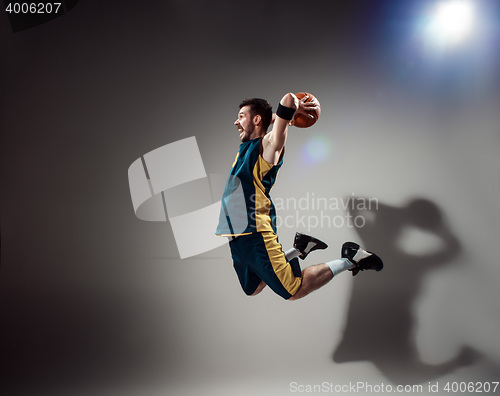 Image of Full length portrait of a basketball player with ball