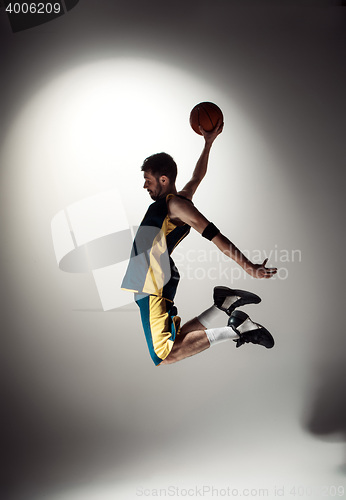 Image of Full length portrait of a basketball player with ball