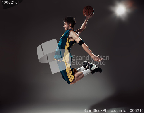 Image of Full length portrait of a basketball player with ball