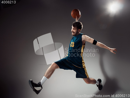 Image of Full length portrait of a basketball player with ball