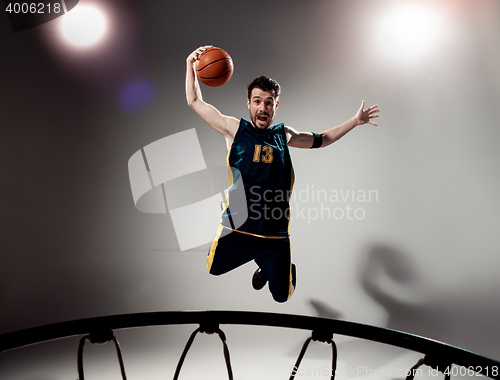 Image of Full length portrait of a basketball player with ball