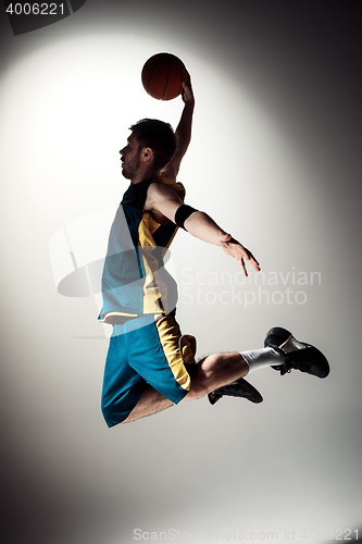 Image of Full length portrait of a basketball player with ball