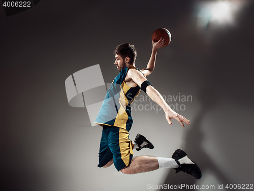 Image of Full length portrait of a basketball player with ball