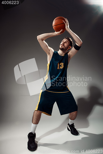 Image of Full length portrait of a basketball player with ball