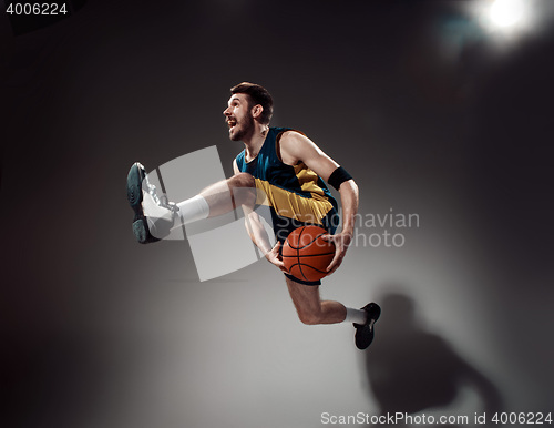 Image of Full length portrait of a basketball player with ball