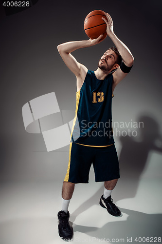 Image of Full length portrait of a basketball player with ball