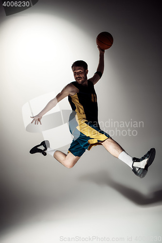 Image of Full length portrait of a basketball player with ball