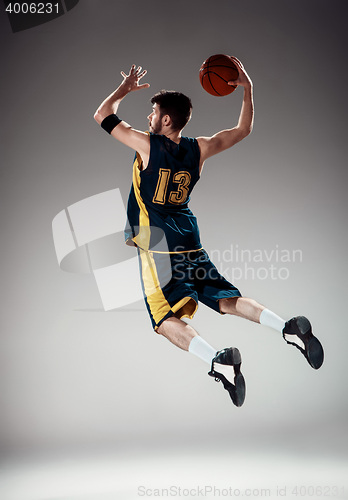 Image of Full length portrait of a basketball player with ball