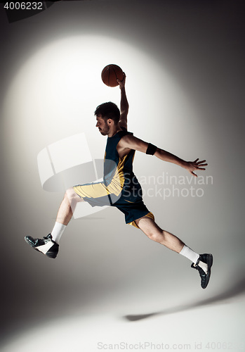 Image of Full length portrait of a basketball player with ball