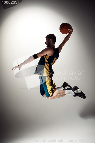 Image of Full length portrait of a basketball player with ball