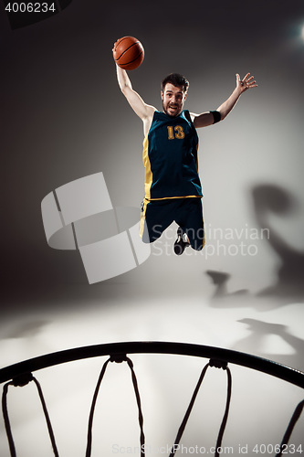 Image of Full length portrait of a basketball player with ball