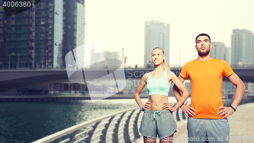Image of couple exercising over dubai city street 