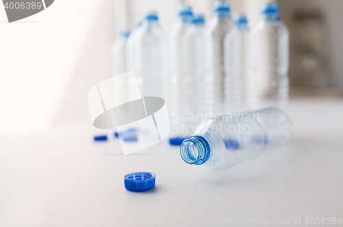 Image of close up of empty water bottles and caps on table