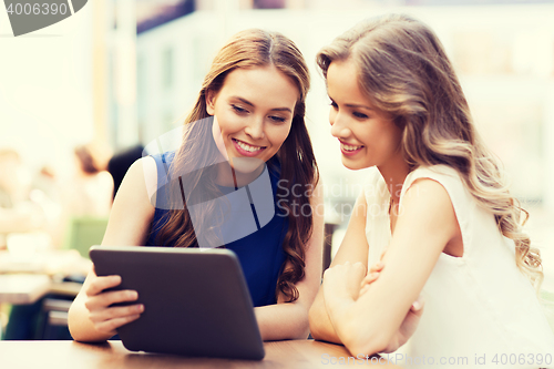 Image of happy young women or teenage girls with tablet pc