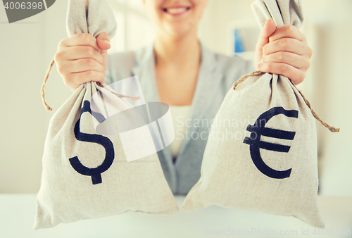 Image of close up of woman hands holding money bags