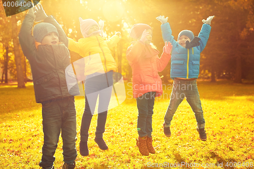 Image of group of happy children having fun in autumn park