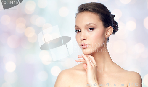 Image of face of beautiful asian woman with golden ring