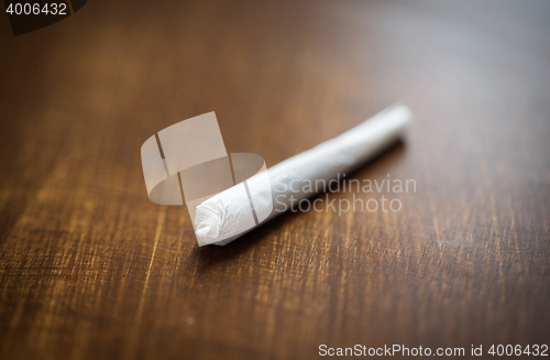 Image of close up of marijuana joint or handmade cigarette