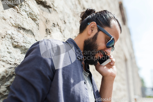 Image of man calling on smartphone at city street