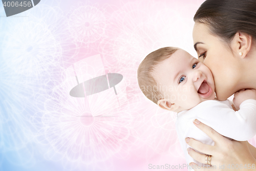 Image of happy mother kissing adorable baby