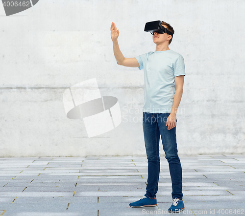 Image of happy man in virtual reality headset or 3d glasses