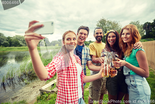 Image of happy friends taking selfie by smartphone