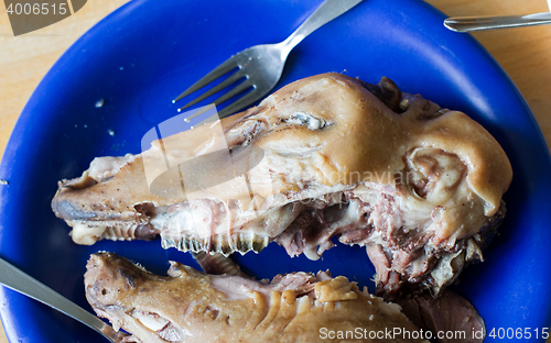 Image of Boiled sheep\'s head on a blue plate - Selective focus on teeth