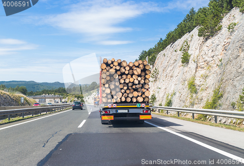 Image of Truck carrying wood on motorway.