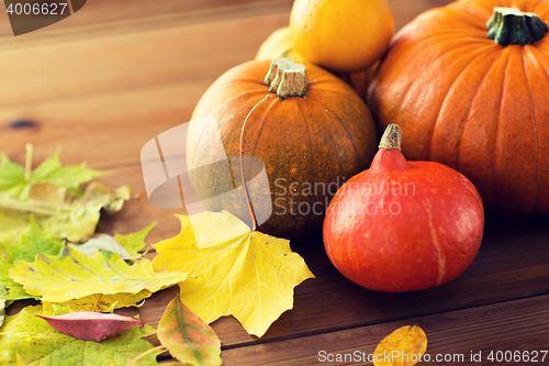 Image of close up of pumpkins on wooden table at home