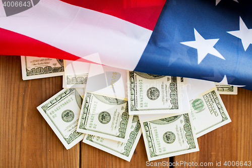 Image of close up of american flag and dollar cash money