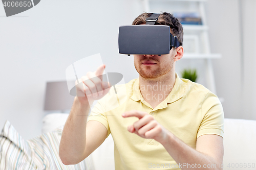 Image of young man in virtual reality headset or 3d glasses