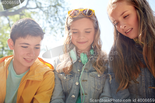 Image of three happy teenage friends headphones