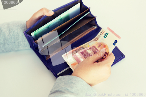 Image of close up of woman hands with wallet and euro money