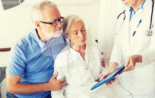 Image of senior woman and doctor with tablet pc at hospital