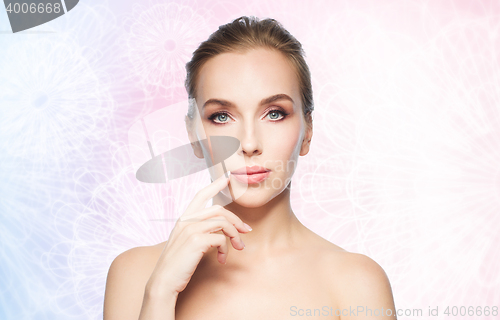 Image of beautiful young woman showing her lips