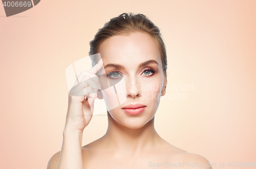 Image of beautiful young woman showing her forehead