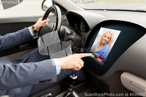 Image of close up of man driving car and receiving call