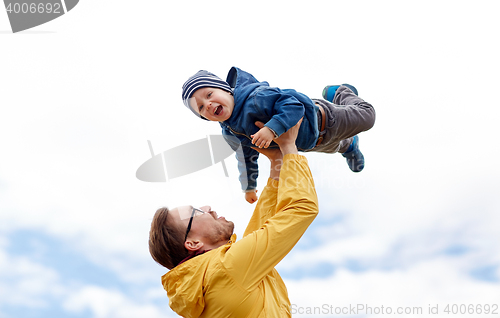 Image of father with son playing and having fun outdoors