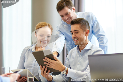 Image of smiling business people meeting in office