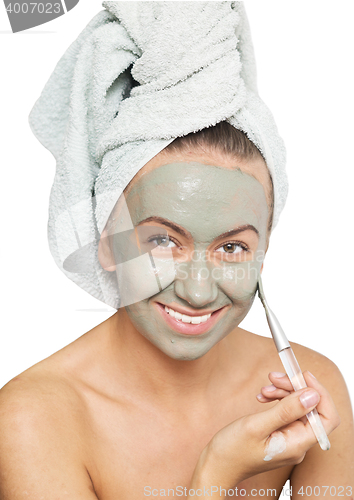 Image of woman applying mask