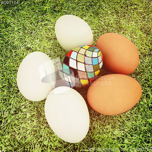 Image of Eggs and easter eggs on the grass. 3D illustration. Vintage styl