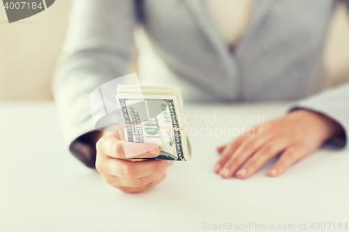 Image of close up of woman hands holding us dollar money