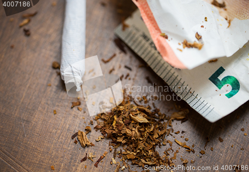 Image of close up of marijuana joint and money